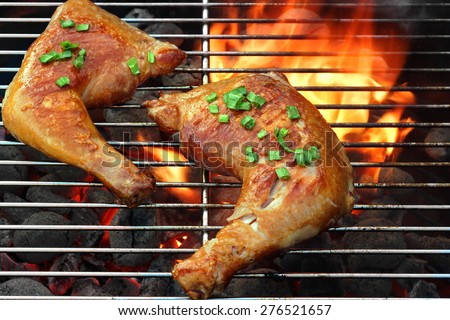 Barbecue Roast And Smoked Chicken Quarters On The Hot Flaming Charcoal Grill Background. Good Food For Outdoor Summer Barbecue Party Or Picnic