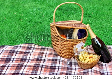 Summer Weekend Picnic With Champagne Wine On The Lawn Close-up Concept. White Signboard With Sign Welcome On The Blanket.