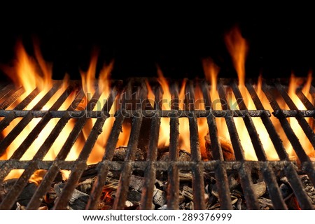 Close-up Of BBQ Grill With Flaming Charcoal Isolated On Black Background
