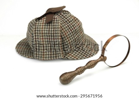 Sherlock Holmes Deerstalker Cap And Vintage Magnifying Glass Isolated On White Background. Investigation Concept