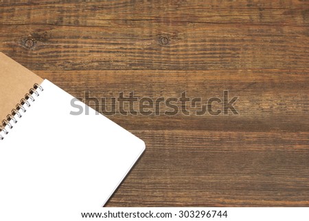 An Open Spiral Bound Notebook With White Pages On The Rough Rustic Wood Table. Overhead View
