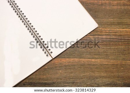 Opened Spiral Bound Notebook With Blank White Pages On The Rustic Rough Brown Wooden Table, Travel Or life Memories Concept