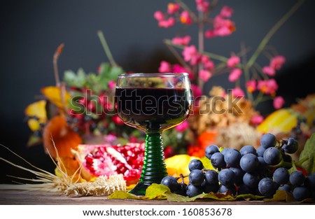 Glass of red wine at autumn evening