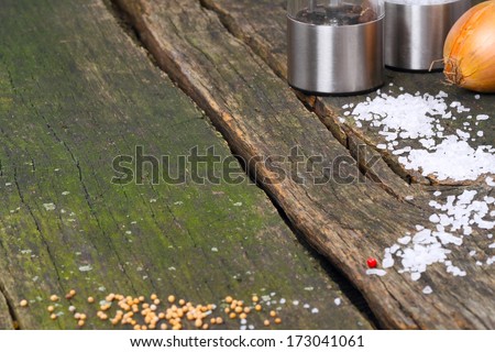Empty wooden table with condiments on the edge