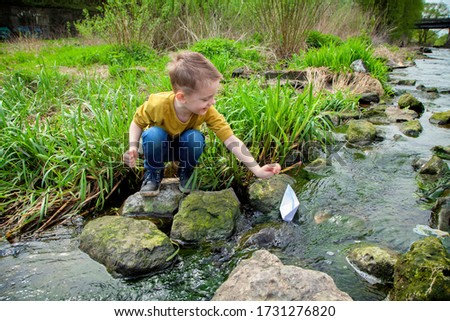 Similar – Image, Stock Photo Child playing with rocks and sand