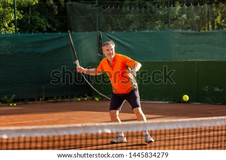 Similar – Image, Stock Photo Senior man playing tennis in gym