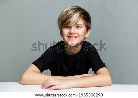 Similar – Image, Stock Photo Boy sits in front of green wall and grins