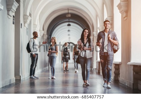 Multiracial students are walking in university hall during break and communicating. 商業照片 © 