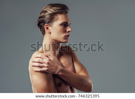 Similar – Image, Stock Photo shirtless caucasian young man wearing turquoise shorts in a park in summer