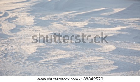 Shadows cast by early light on snow