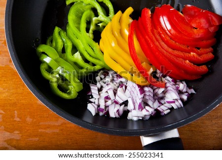 color peppers and onion in pan