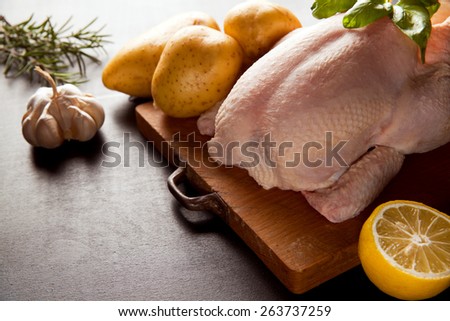 raw whole chicken with potatoes
