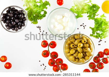 different types of olives and mozzarella with cherry tomatoes and lettuce