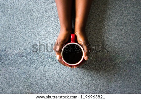 Similar – Image, Stock Photo Hand holding red cup with steaming drink against the light
