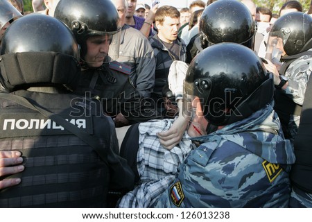 MOSCOW - MAY 6: Injured person is carried away by police during the demonstration against newly elected president Vladimir Putin on May 6, 2012 in Moscow, Russia.