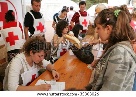 GORI, GEORGIA - SEPTEMBER 8: Red Cross workers distribute food at a refugee camp on September 8, 2008 in Gori, Georgia.