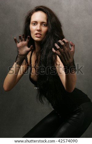 Girl in sexy outfit, gesturing in cat-like manner