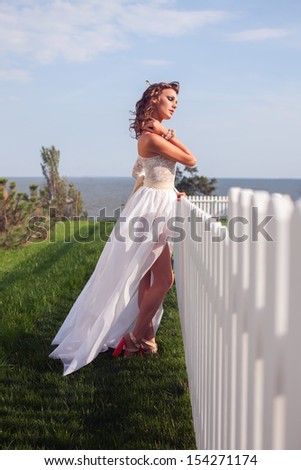 Pretty woman in bride dress. High fashion white and beige dress. couture