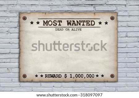 Wanted dead or alive grungy faded posters on brick wall