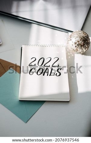 2022 goals, New year resolution. Text 2022 goals in open notepad on the table. Start new year, planning and setting goals for the next year