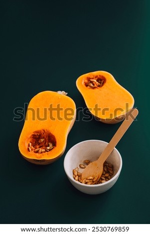 Similar – Image, Stock Photo Halved butternut squash on plate with cutlery and herbs at grey concrete kitchen table background.