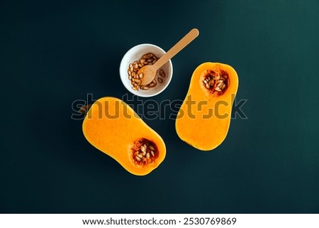 Similar – Image, Stock Photo Halved butternut squash on plate with cutlery and herbs at grey concrete kitchen table background.