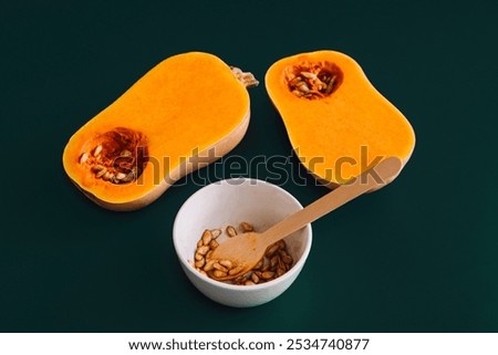 Similar – Image, Stock Photo Halved butternut squash on plate with cutlery and herbs at grey concrete kitchen table background.