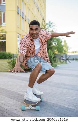 Similar – Image, Stock Photo Smiling man with longboard on street