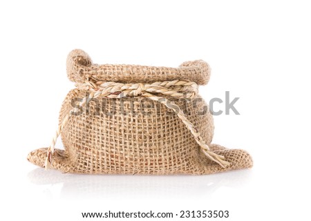 Empty burlap sack with straw ribbon isolated on white background.