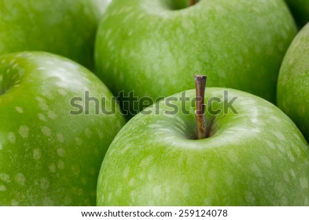 Abstract green apple background macro in selective focus.