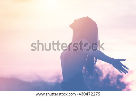 Photo of Young woman relaxing in summer sunset sky outdoor. People freedom style.