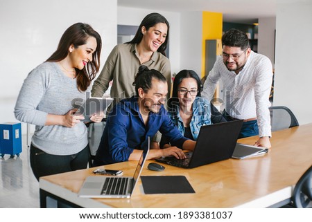 Group of latin business people working together as a teamwork while sitting at the office desk in a creative office in Mexico city Stok fotoğraf © 