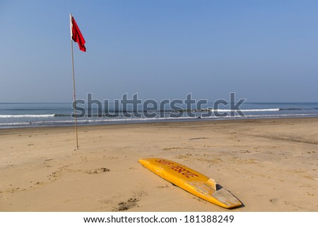 Surf rescue lies on the coast near the flag.