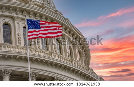 View of the United States Capitol Rotunda Dome in Washington DC with the Star Spangled American Flag against colorful dramatic sunset sky background Stock foto © 