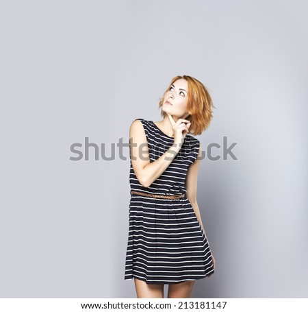 Stylish portrait of a young slim red-haired girl. Young stylish girl. Trend of the season. Urban style.
