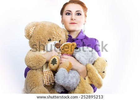 Young girl with a bunch of stuffed animals. Girl with soft toys on a white background