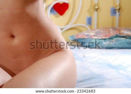 hip and stomach of young woman in bedroom
