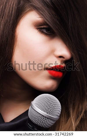 portrait of young beautiful woman with microphone