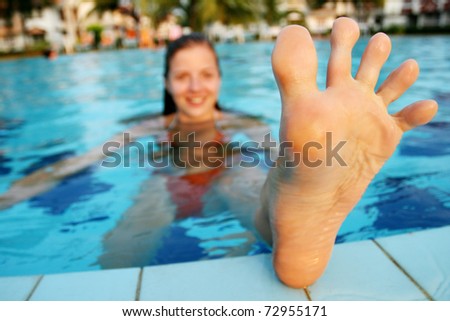 Funny foot of woman in swimming pool