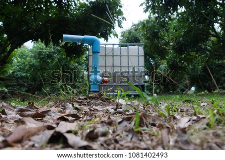 Water Valve P.V.C. in garden,on white plastic chemical tanks background Stock fotó © 