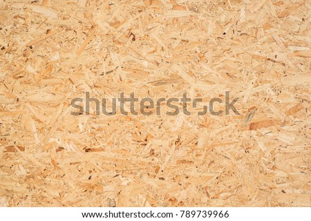 OSB boards are made of brown wood chips sanded into a wooden background. Top view of OSB wood veneer background, tight, seamless surfaces. Foto d'archivio © 
