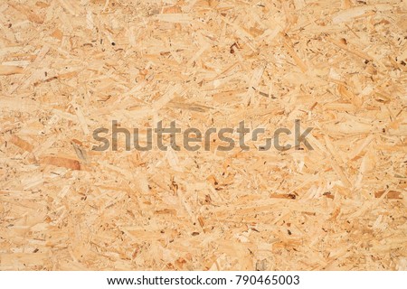 OSB boards are made of brown wood chips sanded into a wooden background. Top view of OSB wood veneer background, tight, seamless surfaces. Foto d'archivio © 