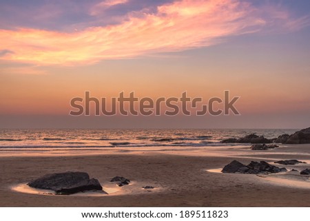Scenic view from sand beach in Goa to beautiful sunset above the Arabian sea