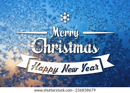 Merry Christmas and New Year greeting card on frozen winter blue colored background