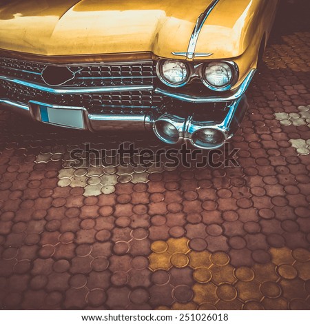 Old retro or vintage car or automobile front side with front lights or headlights and radiator grill. Processed by vintage or retro effect filter