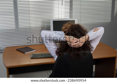 Image of relaxed business woman kepping hands behind head
