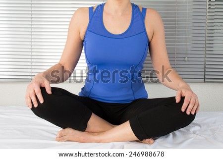 young woman meditating in pose of lotus. Yoga background