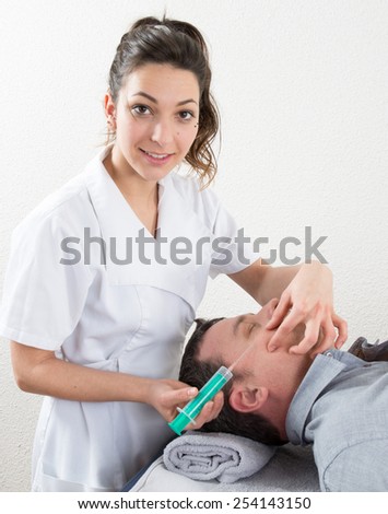 Man gets an injection in her face