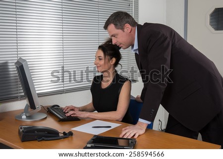 Business people, man and woman meeting and using computer