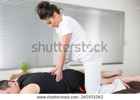One man and woman performing back  massage